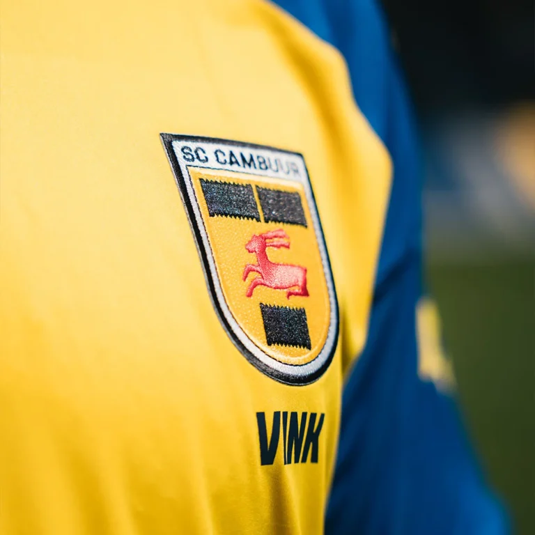 Detailopname van het geborduurde clublogo van SC Cambuur op het thuisshirt voor 2026-2027